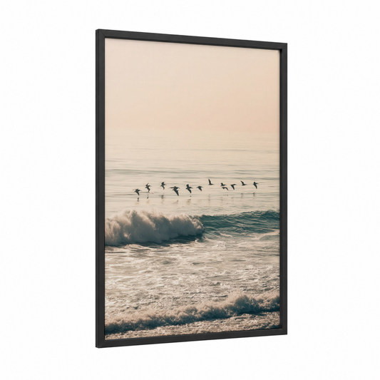 Coastal Pelican Flight framed art print — black wood frame — peach and blue palette