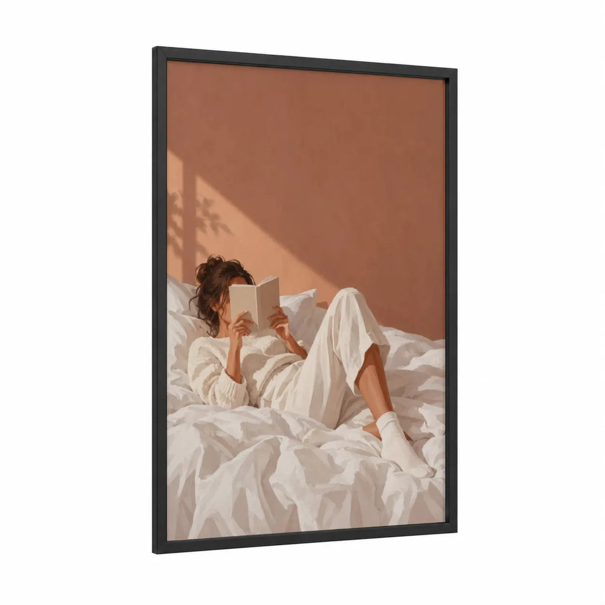 Woman Reading in Bed Wall Art framed art print — black wood frame — cream and peach palette