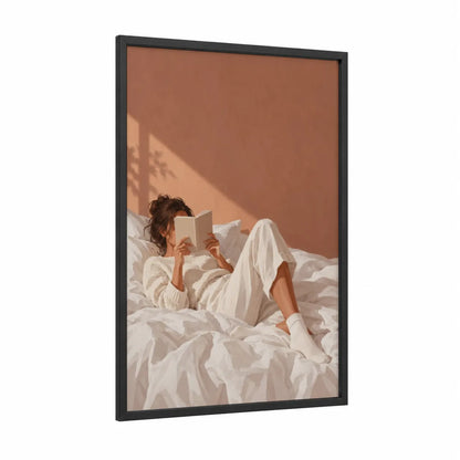 Woman Reading in Bed Wall Art framed art print — black wood frame — cream and peach palette